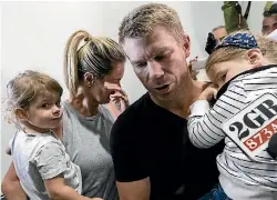  ?? BROOK MITCHELL/GETTY IMAGES ?? David Warner arrives back at Sydney Airport with his wife Candice and their children to face the music.