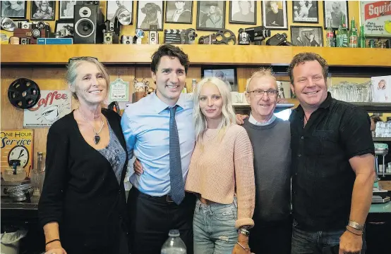  ??  ?? Prime Minister Justin Trudeau was in White Rock on Wednesday with Liberal candidate Gordon Hogg (second from right), where they took a photo with Five Corners Cafe owners Catherine, Shannon and Rice Honeywell. “He’s a rock star,” marvelled Hogg. — CP