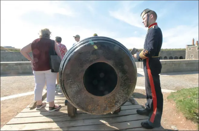  ??  ?? Answering questions from tourists is just part of the job for Craig Hyatt, assistant program manager at the Halifax Citadel Regimental Associatio­n.