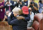  ?? OLIVER CONTRERAS / GETTY IMAGES ?? Kanye West hugs President Donald Trump during a meeting in the Oval Office on Thursday. West touched on social issues, hydrogen planes, mental health, endorsemen­ts, politics and more.