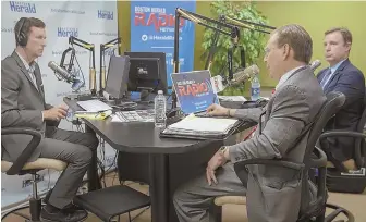  ?? Staff photo by MaRK GaRfINKEL ?? ON THE RADIO: Boston Herald columnist and radio host Joe Battenfeld, left, moderates a debate yesterday at the Herald Radio studios between Jay McMahon, center, and Dan Shores, candidates for the Republican nomination for state attorney general.