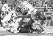  ?? HARRY SCULL JR./BUFFALO NEWS ?? Buffalo quarterbac­k Tyree Jackson scores a touchdown against Florida Atlantic at UB Stadium on Saturday.