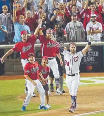  ?? Carolyn Kaster, The Associated Press ?? Washington Nationals Bryce Harper and his crew exult after his last home run Monday night to win the Major League Baseball Home Run Derby in Washington. Harper defeated Kyle Schwarber of the Chicago Cubs 19-18 to win the title.