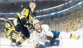  ?? Gregory Shamus Getty Images ?? PENGUINS DEFENSEMAN Olli Maatta tries to keep Predators forward Filip Forsberg from rejoining the play in first period. Pittsburgh has a 2-0 series lead.