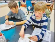  ?? (Submitted Photo) ?? Quinten Thurlo and Andy Evans study the owl pellets.