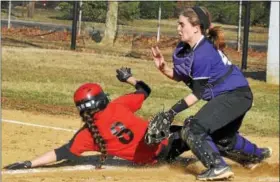  ?? BARRY TAGLIEBER - FOR THE PHOENIX ?? Phoenixvil­le catcher Taylor Crown handles a throw to home plate as Boyertown’s Becky Marburger (8) slides in safely with a run scored during the two schools’ PAC-10softball game.