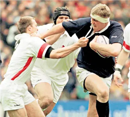  ??  ?? No nonsense: Doddie Weir in typical action for Scotland, fending off Matt Dawson at Murrayfiel­d in 1998