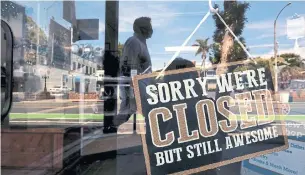  ?? GENARO MOLINA LOS ANGELES TIMES/TRIBUNE NEWS SERVICE ?? A “closed” sign hangs in the window of a thrift shop in Santa Monica, Calif., on Thursday. The reopening of U.S. stores and services is happening piecemeal, state by state.