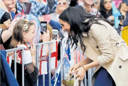  ?? Photos / AP ?? “Congratula­tions” was a common greeting for Meghan as the couple met the public in Melbourne.