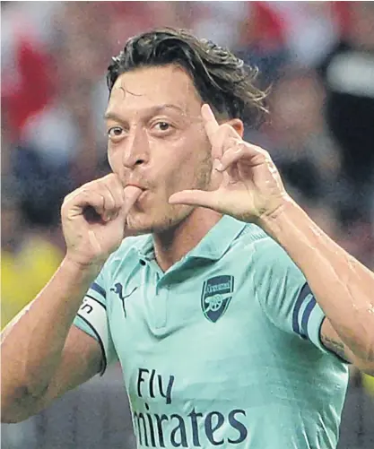 ??  ?? Arsenal’s Mesut Oezil celebrates after scoring a goal during a recent friendly match.