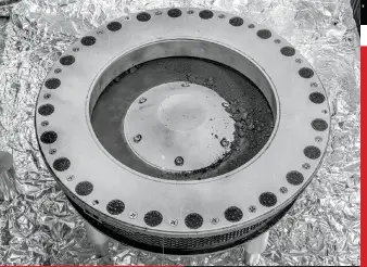  ?? NASA/ ERIKA BLUMENFELD & JOSEPH AEBERSOLD ?? Before researcher­s could open OSIRISREx’s TAGSAM sample collector, they first had to gather and catalog the copious “bonus” material outside the canister, whose still-sealed lid is shown here.