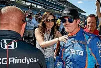  ?? PHOTO: PHOTOSPORT ?? ‘‘It will make you feel really small again,’’ said Scott Dixon, right, of being robbed at gunpoint hours after securing pole position for the Indianapol­is 500.