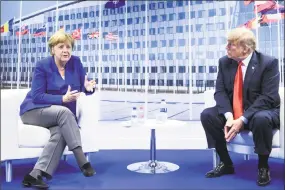  ?? Brendan Smialowski / AFP/Getty Images ?? German Chancellor Angela Merkel and President Donald Trump make a statement to the press after a bilateral meeting at the NATO summit on Wednesday in Brussels.