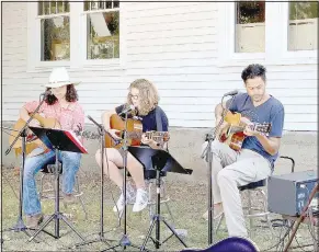  ?? (NWA Democrat-Gazette/ Lynn Kutter) ?? Remington ( from left), Peyton Orona of Prairie Grove and Jacob Phaneuf, owner of Inside Out Studio in Farmington, play at the Prairie Grove Farmers Market.