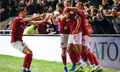  ??  ?? Josh Brownhill is mobbed after scoring Bristol City’s winner. Photograph: Rogan/JMP/Shuttersto­ck