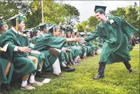  ?? Catherine Avalone / Hearst Connecticu­t Media ?? Austin Fix, left, congratula­tes Jared Newman after he received his diploma at the Guilford High School commenceme­nt exercises on the Guilford Town Green Friday.