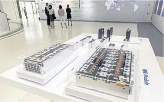  ??  ?? Cross-sections of electric vehicle batteries are displayed in the welcome centre at the CATL headquarte­rs.