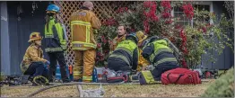  ?? Bobby Block/The Signal ?? First responders perform CPR on a victim removed from a house fire in Canyon Country. Two people died in the blaze.