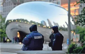  ?? CHARLES REX ARBOGAST/AP ?? Private security personnel patrol the area around Chicago’s Cloud Gate sculpture on Thursday. In Chicago, mayors face annual pressure to demonstrat­e a proactive approach to violent crime ahead of Memorial Day, the traditiona­l kickoff to summer events where crowds gather.