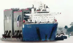  ??  ?? PANAMA CANAL GATES (EPA) – A ship transports the last four gates to be used in the extension works of the Panama Interocean­ic Canal in Colon, Panama, November 12, 2014.