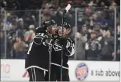  ?? JAE C. HONG — THE ASSOCIATED PRESS ?? The Kings’ Vladislav Gavrikov, left, and Trevor Moore celebrate Gavrikov’s OT goal against Tampa Bay.