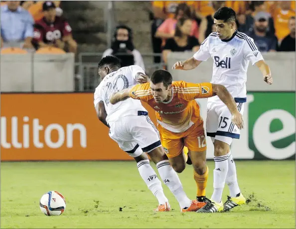 ??  ?? Houston Dynamo forward Will Bruin attempts to break through the Whitecaps defence last year in Houston. The Caps play two games in Texas this July, when the temperatur­es average in the mid-90s F (mid-30s C) in Dallas and Houston.