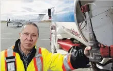  ?? CLIFFORD SKARSTEDT EXAMINER ?? Fixed based operation manager Alfred Ho of Stewart Aviation gives a tour of fuel trucks on the tarmac at the Peterborou­gh Airport Thursday.