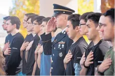  ??  ?? Sgt. 1st Class Nicholas Kelly, center, salutes during the Pledge of Allegiance, surrounded by a group of new Army recruits who took the Oath of Enlistment Saturday.