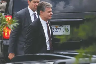  ?? The Associated Press ?? DIRECTOR: FBI Director Christophe­r Wray, right, leaves the White House, Monday in Washington.