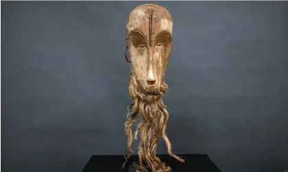  ?? Pascal Guyot/AFP/Getty Images ?? The ‘Ngil’ mask, made by the Fang people of Gabon, was sold at auction in Montpellie­r, France, for €4.2m in March 2022. Photograph: