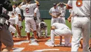  ?? STEPHEN SPILLMAN / FOR AUSTIN AMERICAN-STATESMAN ?? Texas players celebrate in center field after clinching their series with a 5-2 win over Tennessee Tech in Austin on Monday.