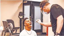  ?? OF OSU ATHLETICS] ?? Oklahoma State football player Tylan Wallace gets tested for COVID19 inside the OSU football facility Monday. [BRUCE WATERFIELD/COURTESY