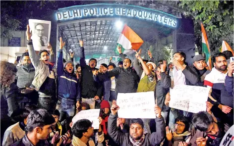  ?? — AFP photo ?? Demonstrat­ors shout slogans outside the Delhi Police Headquarte­rs to protest following alleged clashes between student groups at Jawaharlal Nehru University (JNU) in New Delhi.