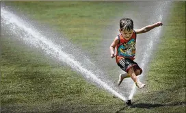  ?? RALPH BARRERA / AMERICAN-STATESMAN ?? Connor Santos, 3, has fun jumping in the sprinkler in Zilker Park’s Great Lawn last month. His mother, Amy Santos, took him to the park for a play day. The average temperatur­e in August was 88.7 degrees, making it the third-warmest August on record.