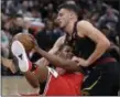  ?? NAM Y. HUH — THE ASSOCIATED PRESS ?? Bulls center Cristiano Felicio, left, battles for a loose ball against Cavaliers center Ante Zizic during the first half.