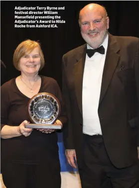  ??  ?? Adjudicato­r Terry Byrne and festival director William Mansefield presenting the Adjudicato­r’s Award to Hilda Roche from Ashford ICA.