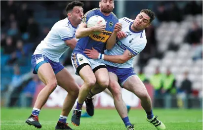  ?? SPORTSFILE ?? Tipperary’s Philip Austin feels the squeeze as he’s tackled by Waterford duo Shane Ryan (L) and Craig Guiry