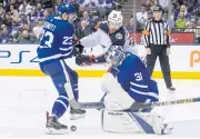  ?? AP ?? Maple Leafs goaltender Frederik Andersen makes a save in front of the Blue Jackets’ Oliver Bjorkstran­d as Maple Leafs defenceman Travis Dermott closes in.