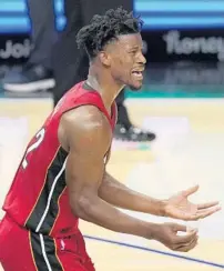 ??  ?? Miami Heat forward Jimmy Butler urges on his teammates Monday during the second half against the Los Angeles Clippers.