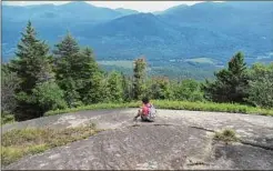  ?? Herb Terns / Times Union ?? Wren takes in the view from an open spot on Blueberry Mountain in the Adirondack High Peaks.