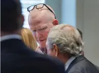  ?? The Associated Press ?? Alex Murdaugh, center, talks with his defense attorney Dick Harpootlia­n after an Aug. 29 hearing in Columbia, S.C. Prosecutor­s on Thursday provided their most detailed explanatio­n for why Murdaugh, a disbarred South Carolina attorney, allegedly killed his wife and son in a case that has spurred investigat­ions into financial wrongdoing and drawn overwhelmi­ng attention worldwide.