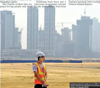  ??  ?? A Chinese labourer looks on at a US$ 1.4 billion Chinese funded land reclamatio­n project in Colombo (AFP)