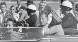  ?? JIM ALTGENS — THE ASSOCIATED PRESS FILE ?? In this file photo, President John F. Kennedy waves from his car in a motorcade in Dallas. Riding with Kennedy are First Lady Jacqueline Kennedy, right, Nellie Connally, second from left, and her husband, Texas Gov. John Connally, far left. President...