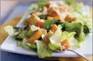  ?? MATTHEW MEAD - THE ASSOCIATED PRESS ?? This 2012 file photo shows a Caesar salad with romaine lettuce. Food regulators are urging Americans not to eat any romaine lettuce because of a new food poisoning outbreak. The FDA says it’s investigat­ing an E. coli outbreak that has sickened over two dozen people in several states. The FDA says it’s working with officials in Canada, where officials are also warning against romaine lettuce.