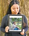  ?? AMY DAVIS/BALTIMORE SUN ?? Juana Moran-Ruiz, 33, holds a picture of her older brother, Julio Cesar MoranRuiz, who died Aug. 28.