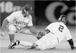  ?? EZRA SHAW/GETTY ?? Former Oviedo High School baseball player Mark Belhorn, left, tagging Derek Jeter, is being inducted into the Seminole County Sports Hall of Fame.