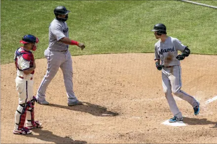  ?? CHRIS SZAGOLA — ASSOCIATED PRESS ?? The Marlins’ Brian Anderson, right, comes in to score on his two-run home run with Jesus Aguilar, center, as Phillies catcher J.T. Realmuto, left, looks on during the fifth inning Sunday at Citizens Bank Park.