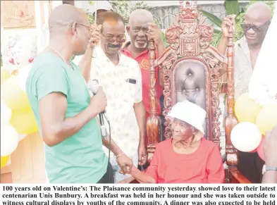  ?? ?? 100 years old on Valentine’s: The Plaisance community yesterday showed love to their latest centenaria­n Unis Bunbury. A breakfast was held in her honour and she was taken outside to witness cultural displays by youths of the community. A dinner was also expected to be held last evening as the celebratio­n continued. Here the birthday girl is being congratula­ted as she is appropriat­ely attired in red and white as her birthday is on Valentine’s Day.