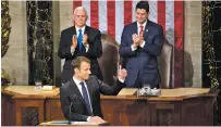  ?? ERIC THAYER/THE NEW YORK TIMES ?? Vice President Mike Pence and House Speaker Paul Ryan applaud as French President Emmanuel Macron addresses a joint meeting of Congress on Wednesday in the House Chamber of the U.S. Capitol in Washington.