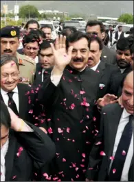  ??  ?? CONTEMPT: Pakistani Prime Minister Yousuf Raza Gilani, center, makes his way to the Supreme Court for a hearing on Thursday in Islamabad, Pakistan. The Supreme Court convicted Gilani of contempt on Thursday for refusing to reopen an old corruption case...